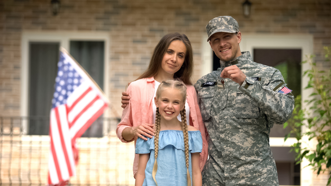 Veteran military couple holding house keys