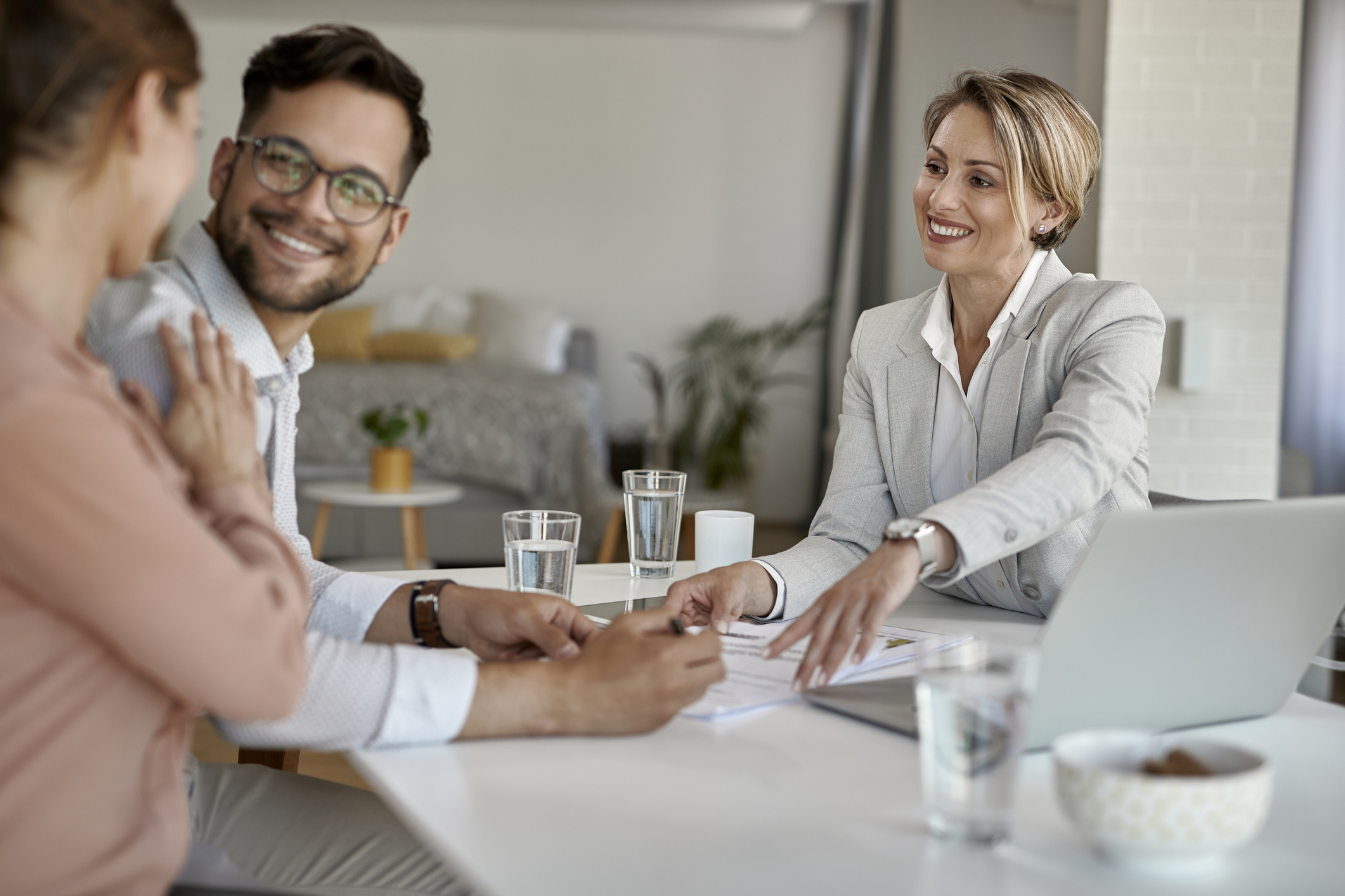 Conventional Loans - Couple signing documents with mortgage broker in Tucson